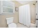 Simple, bright bathroom with a shower and a window for natural light at 2065 Innsfail Dr, Snellville, GA 30078