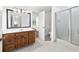 Bathroom featuring a vanity, a large mirror with lighting, and a glass enclosed shower at 2065 Innsfail Dr, Snellville, GA 30078