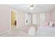 Spacious bedroom features a ceiling fan, a comfortable daybed, and has access to an ensuite bathroom at 2065 Innsfail Dr, Snellville, GA 30078