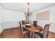 Elegant dining room features a chandelier, hardwood floors, and neutral wall paint, creating an inviting atmosphere at 2065 Innsfail Dr, Snellville, GA 30078