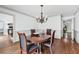 Elegant dining room features a chandelier, hardwood floors, and neutral wall paint, creating an inviting atmosphere at 2065 Innsfail Dr, Snellville, GA 30078