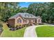 Lovely brick home with manicured lawn and landscaping, showcasing charm at 2065 Innsfail Dr, Snellville, GA 30078