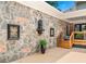 Charming stone and brick exterior featuring a unique water feature and wooden stairs leading to an upper level at 2065 Innsfail Dr, Snellville, GA 30078