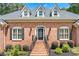 Inviting front entrance with brick stairs, manicured landscaping, and decorative front door with sidelights at 2065 Innsfail Dr, Snellville, GA 30078