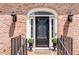 Close up of a beautifully decorated front door with sidelights and brick entryway at 2065 Innsfail Dr, Snellville, GA 30078