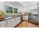 Spacious kitchen featuring granite countertops, a stainless steel refrigerator, and hardwood flooring at 2065 Innsfail Dr, Snellville, GA 30078