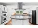 Bright and modern kitchen with stainless steel appliances, granite counters, and eat-in island at 2065 Innsfail Dr, Snellville, GA 30078