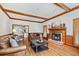 Open concept living area with wood burning fireplace, hardwood flooring, and comfortable sofas at 2065 Innsfail Dr, Snellville, GA 30078