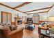 Inviting living room with hardwood floors, wood beams, brick fireplace, and comfortable leather furniture at 2065 Innsfail Dr, Snellville, GA 30078