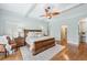 Spacious main bedroom featuring hardwood floors, a ceiling fan, and shuttered windows at 2065 Innsfail Dr, Snellville, GA 30078