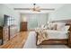 Bright main bedroom with hardwood floors, white trim, and a large window with plantation shutters at 2065 Innsfail Dr, Snellville, GA 30078