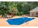 Beautiful backyard pool featuring a gazebo, lounge chairs, and lush landscaping, creating a private oasis for relaxation at 2065 Innsfail Dr, Snellville, GA 30078