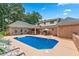 A sparkling pool with a sunbathing deck is surrounded by privacy fencing at 2065 Innsfail Dr, Snellville, GA 30078