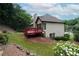 Expansive backyard with a red deck, offering outdoor space, complemented by mature trees at 655 Golden Meadows Ln, Suwanee, GA 30024