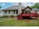 Back exterior view showcasing a spacious backyard, red deck, and traditional siding at 655 Golden Meadows Ln, Suwanee, GA 30024