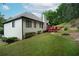 The backyard has a red deck and a stone firepit area, with landscaping, great for entertaining at 655 Golden Meadows Ln, Suwanee, GA 30024
