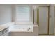 Bright bathroom with a soaking tub and a glass shower at 655 Golden Meadows Ln, Suwanee, GA 30024