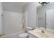 Well-lit bathroom features a shower-tub combo, sink with vanity, and a mirrored wall at 655 Golden Meadows Ln, Suwanee, GA 30024