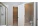 Bathroom featuring a shower and view into the closet and a water closet at 655 Golden Meadows Ln, Suwanee, GA 30024