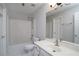 Bright bathroom with a shower-tub combo and a large mirror at 655 Golden Meadows Ln, Suwanee, GA 30024