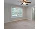 Bedroom with ceiling fan and window with view to trees, offering ample natural light at 655 Golden Meadows Ln, Suwanee, GA 30024