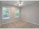Bright bedroom with two large windows and ceiling fan, offering ample natural light at 655 Golden Meadows Ln, Suwanee, GA 30024