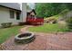 Backyard brick fire pit and wood path create a cozy outdoor gathering spot at 655 Golden Meadows Ln, Suwanee, GA 30024