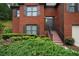 Charming front entrance with brick steps, black railings, and lush greenery surrounding the walkway at 655 Golden Meadows Ln, Suwanee, GA 30024