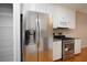 Modern kitchen with stainless steel refrigerator and range oven, and granite countertops at 655 Golden Meadows Ln, Suwanee, GA 30024