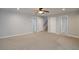 Large, neutral carpeted living room with multiple doorways, perfect for entertaining guests at 655 Golden Meadows Ln, Suwanee, GA 30024
