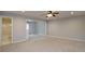 Open-concept living room with neutral carpet and adjacent bathroom, creating a seamless flow at 655 Golden Meadows Ln, Suwanee, GA 30024