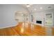 Bright living room with hardwood floors, fireplace, and large windows showcasing outdoor views at 655 Golden Meadows Ln, Suwanee, GA 30024