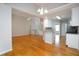 Open-concept living area with hardwood floors, seamlessly connecting to the kitchen and breakfast nook at 655 Golden Meadows Ln, Suwanee, GA 30024