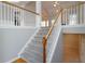 Elegant staircase with wood railing and white spindles leads to the upper level at 655 Golden Meadows Ln, Suwanee, GA 30024