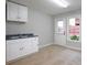 Utility room with white cabinets, sink, and natural light creating a functional space at 655 Golden Meadows Ln, Suwanee, GA 30024