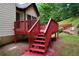 Backyard features a red wooden deck, providing a great space for relaxation and outdoor activities at 655 Golden Meadows Ln, Suwanee, GA 30024