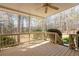 Inviting covered back porch with wood railing overlooking the backyard and trees at 115 Flagstop Run, Fayetteville, GA 30215