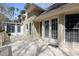 Exterior view of the spacious wood deck with doors leading into the home and sunroom at 115 Flagstop Run, Fayetteville, GA 30215