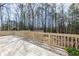 Spacious wood deck with railing overlooking a natural backyard and mature trees at 115 Flagstop Run, Fayetteville, GA 30215