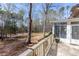 Wood deck featuring railing, a potted plant, and views of a natural, wooded backyard at 115 Flagstop Run, Fayetteville, GA 30215
