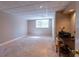 Finished basement area with carpeted flooring, natural light, and a built-in desk at 115 Flagstop Run, Fayetteville, GA 30215