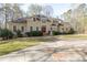 A sprawling front yard leading to the home's entrance, with mature trees at 115 Flagstop Run, Fayetteville, GA 30215