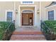 Inviting front entrance featuring brick steps, decorative sidelights, a transom window, and a glimpse into the foyer at 115 Flagstop Run, Fayetteville, GA 30215