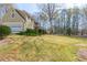 Spacious front yard with lush green lawn and mature trees complementing the home's exterior at 115 Flagstop Run, Fayetteville, GA 30215