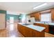 Spacious kitchen featuring a central island, wood cabinets, and access to a dining area at 115 Flagstop Run, Fayetteville, GA 30215