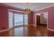 Living room with hardwood floors, bay window, chandelier and pink walls at 115 Flagstop Run, Fayetteville, GA 30215