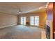 Cozy living room with fireplace, french doors, and ample space at 115 Flagstop Run, Fayetteville, GA 30215