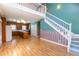 Open living space features hardwood floors, staircase, and eat-in kitchen at 115 Flagstop Run, Fayetteville, GA 30215