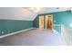 A large open loft area features a ceiling fan and multiple entranceways at 115 Flagstop Run, Fayetteville, GA 30215