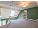 Bright loft area features a ceiling fan, a skylight, and access to an upstairs hallway at 115 Flagstop Run, Fayetteville, GA 30215